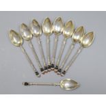 A set of nine early to mid 20th century Austro Hungarian white metal and enamel coffee spoons,