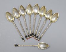 A set of nine early to mid 20th century Austro Hungarian white metal and enamel coffee spoons,