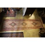 A North West Persian red ground rug, 280 x 140cm, together with a runner