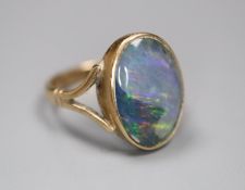 A 9ct and opal doublet set oval ring, size J, gross 2.7 grams.