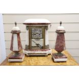 An Art Deco rouge and white marble clock garniture