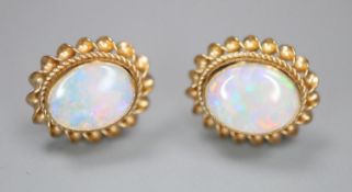 A modern pair of 9ct gold and white opal oval earrings, no butterflies, gross 1.1 grams.