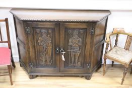 A medieval style carved oak side cabinet, width 120cm, depth 38cm, height 81cm