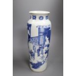 A Chinese Transitional blue and white sleeve vase, c.1640, 40cm high painted with court figures in a