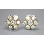 A pair of white metal and seven stone diamond set flower head cluster earrings, 8mm, gross 2.6