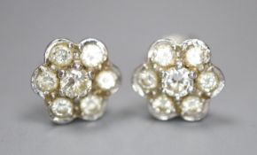 A pair of white metal and seven stone diamond set flower head cluster earrings, 8mm, gross 2.6