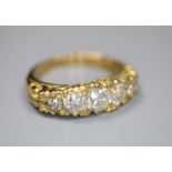 A modern Victorian style 18ct gold and graduated old round cut diamond set half hoop ring, with