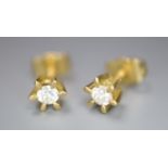 A small pair of modern 18ct gold and solitaire diamond earstuds, gross 1.4 grams.