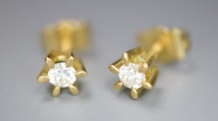 A small pair of modern 18ct gold and solitaire diamond earstuds, gross 1.4 grams.