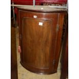 A George III walnut bowfront hanging corner cabinet, width 62cm, depth 42cm, height 88cm