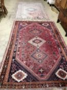 A Caucasian style peach ground rug, 260 x 160cm together with one other