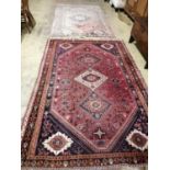 A Caucasian style peach ground rug, 260 x 160cm together with one other