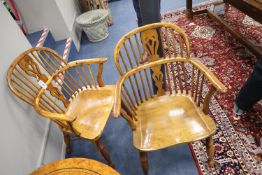 A pair of reproduction yew and elm Windsor elbow chairs