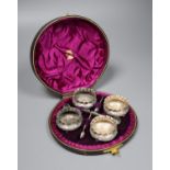 A cased set of four Victorian silver circular salts, Birmingham, 1886 and four spoons.
