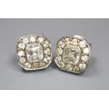 A pair of 750 white metal and octagonal diamond cluster ear studs, with asscher? cut central stones,