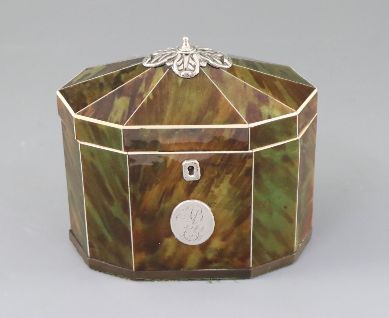 A George III silver mounted green stained tortoiseshell and ivory tea caddy, of decagonal form, with