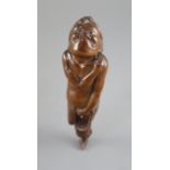 A Japanese cherrywood okimono netsuke of a farmer, early 19th century, the figure with gurning