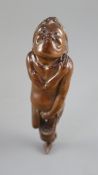 A Japanese cherrywood okimono netsuke of a farmer, early 19th century, the figure with gurning