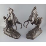 After Guillaume Coustou the Elder (French 1677-1746). A pair of bronze Chevaux de Marly, signed N.
