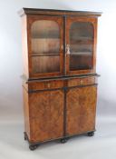 An 18th century Dutch walnut, olivewood and ebony bookcase, with moulded cornice and two arched