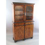 An 18th century Dutch walnut, olivewood and ebony bookcase, with moulded cornice and two arched