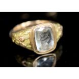 A William IV two colour gold and 'JA' monogrammed aquamarine set ring, with foliate shoulders in