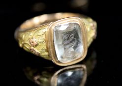 A William IV two colour gold and 'JA' monogrammed aquamarine set ring, with foliate shoulders in