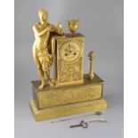 A 19th century French Empire style ormolu mantel clock, modelled with a classical musician