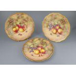 Three Royal Worcester fruit painted dinner plates, post-war, painted by Freeman, within gilt
