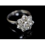 A modern 18ct white gold and eight stone diamond cluster flower head ring, size R/S, gross 4.8