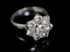 A modern 18ct white gold and eight stone diamond cluster flower head ring, size R/S, gross 4.8