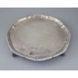 A modern silver shaped circular salver, by Viners Ltd, with gadrooned border, on four scroll feet,