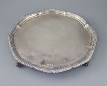 A modern silver shaped circular salver, by Viners Ltd, with gadrooned border, on four scroll feet,