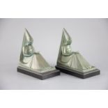 Max le Verrier. A pair of Art Deco patinated bronze bookends, modelled as seated medieval maidens,