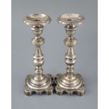 Two 19th century Brazilian? cast silver candlesticks, with engraved decoration and waisted knopped