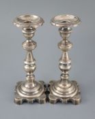 Two 19th century Brazilian? cast silver candlesticks, with engraved decoration and waisted knopped