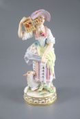 A Meissen figure of a shepherdess releasing a bird from a cage, 19th century, crossed swords mark