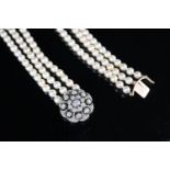 A modern triple row cultured pearl necklace with an earlier Victorian gold, silver and diamond