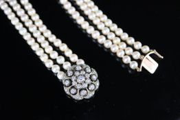 A modern triple row cultured pearl necklace with an earlier Victorian gold, silver and diamond