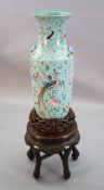 A large Chinese famille rose turquoise ground baluster vase, first half 19th century, painted with