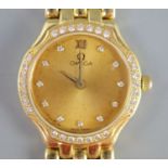 A lady's 18ct. gold Omega quartz wrist watch with diamond set bezel and numerals, on 18ct gold Omega