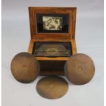 A Victorian German walnut symphonion, with stencil decorated lid and gilt bronze handles, the