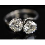 A platinum? and two stone diamond crossover ring, the two stones weighing approximately 1.10ct and