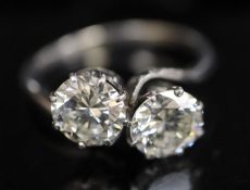 A platinum? and two stone diamond crossover ring, the two stones weighing approximately 1.10ct and