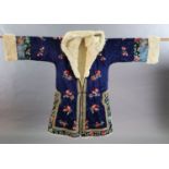 A Chinese blue silk multicoloured embroidered Chinese winter robe, early 20th century, with a