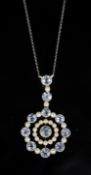 An Edwardian 15ct gold, aquamarine and seed pearl set circular drop pendant necklace, on a platinum?