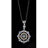 An Edwardian 15ct gold, aquamarine and seed pearl set circular drop pendant necklace, on a platinum?
