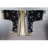 A Chinese black silk multi-coloured embroidered three quarter length winter jacket, late 19th