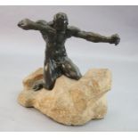 Alfredo Pina (1883-1966). A bronze figure of Héraclès kneeling upon a rocky mound, signed on the