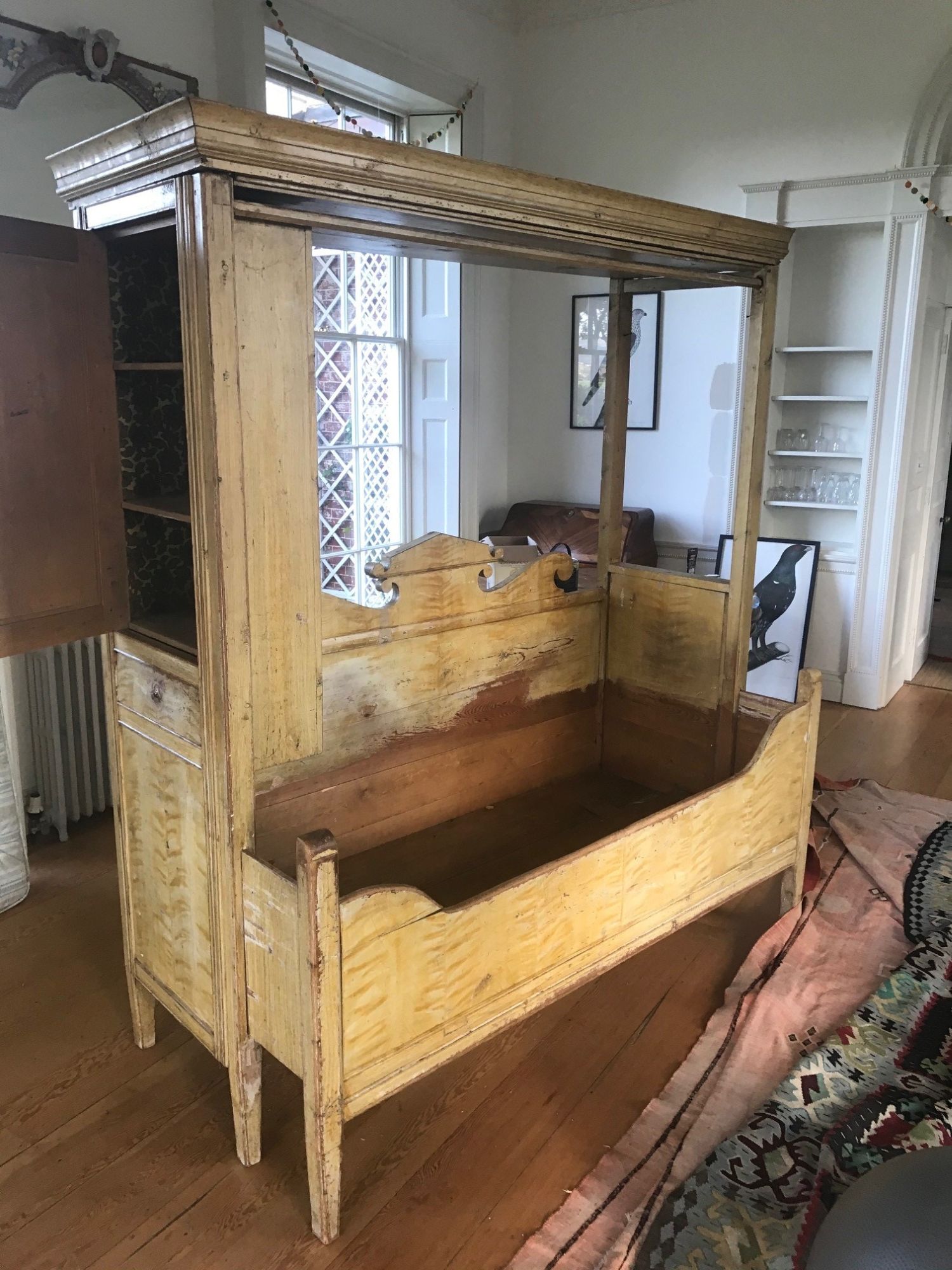 A 19th Swedish grained pine extending box bed, combined cupboard, with moulded cornice and front